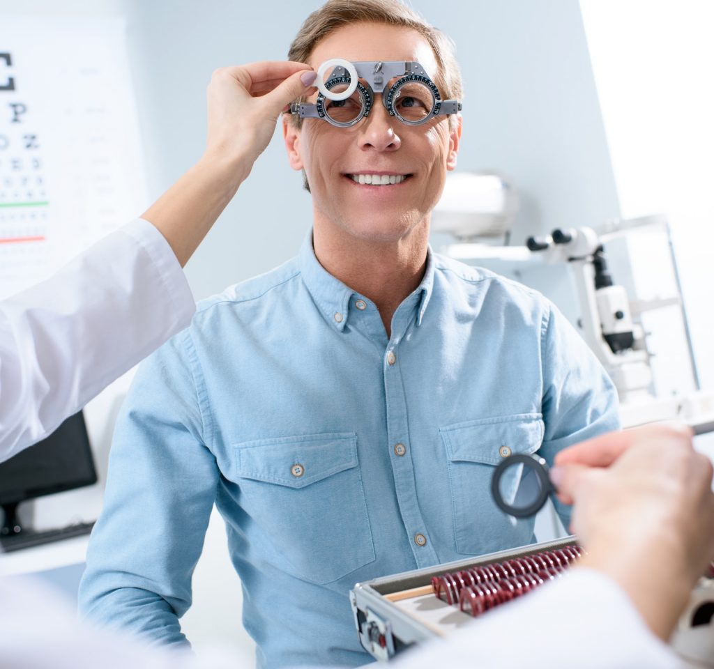 ophthalmologist-examining-middle-aged-man-eyes-with-trial-frame-and-lenses.jpg